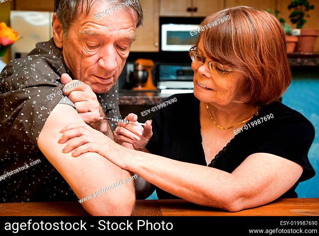 Man and woman with small hypodermic needle