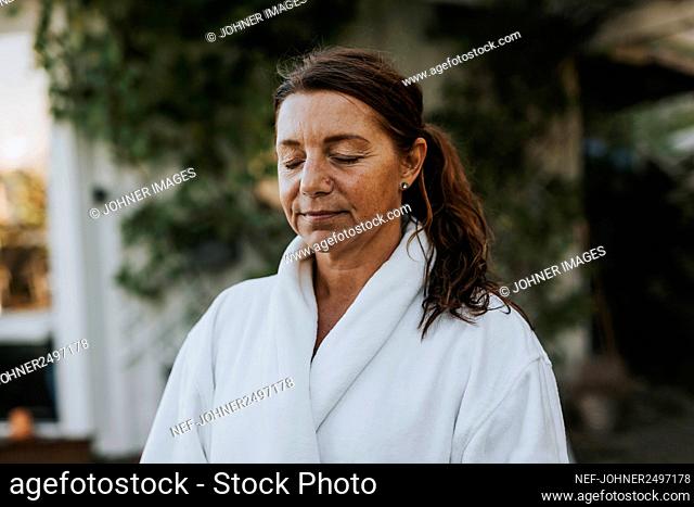 Mature woman with eyes closed