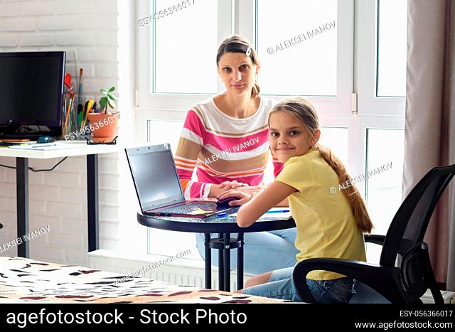 The tutor is teaching the child, both looked into the frame