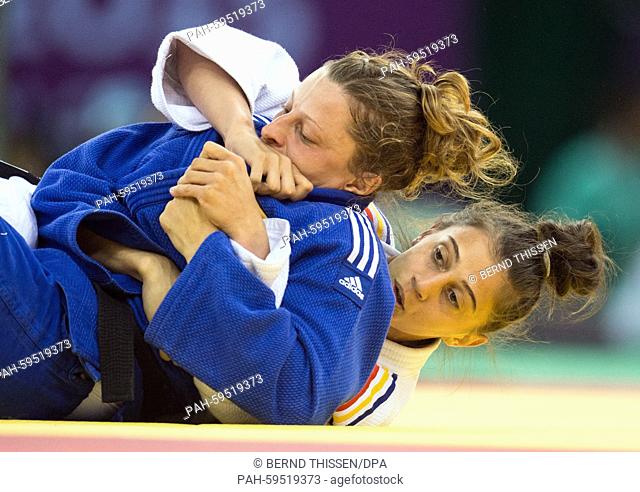 Germanys Mareen Kraeh (blue) competes with Larisa Florian of Romania in the Women's -52kg Judo Women's Bronze Final A at the Baku 2015 European Games in Heydar...