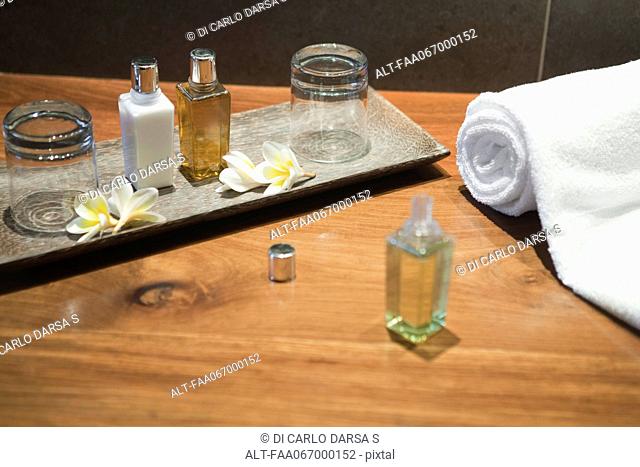 Perfume bottles and frangipani flowers on tray