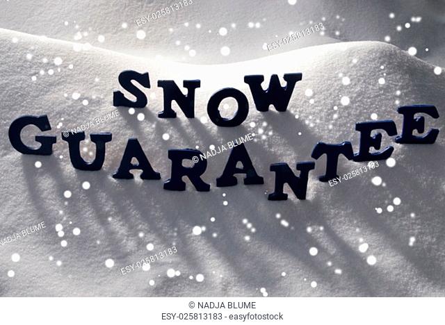 Blue Letters Building English Text Snow Guarantee On White Snow. Snowy Landscape Or Scenery With Snowflakes. Christmas Card For Seasons Greetings Or Usable As...