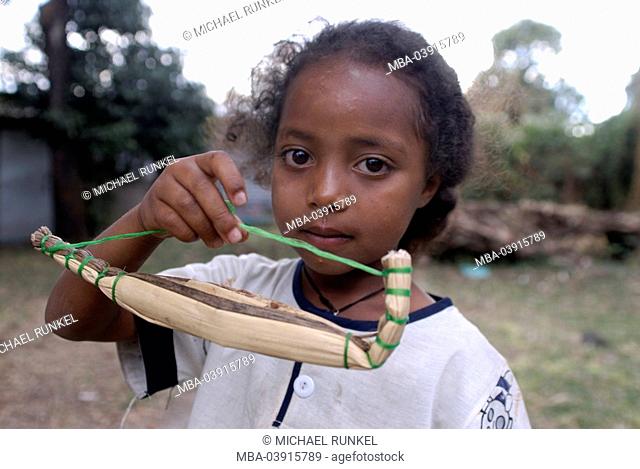 Ethiopia, Tana-lake, girl, toy, papyrus-boat, shows, portrait, Africa, East-Africa, people, natives, people, colored, child, stands, boat, toy-boat, homemade