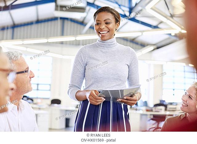 Smiling businesswoman leading meeting