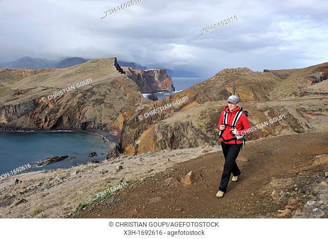 young woman walking along the Abra bay, Sao Lourenco peninsula, Madeira island, Atlantic Ocean, Portugal