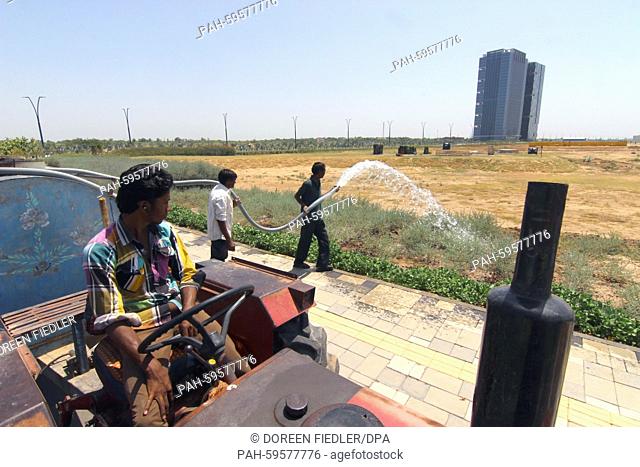 Gardeners water the plants in the satellite town GIFT City (Gujarat International Finance Tec-City) in Gandhinagar, India, 16 May 2015