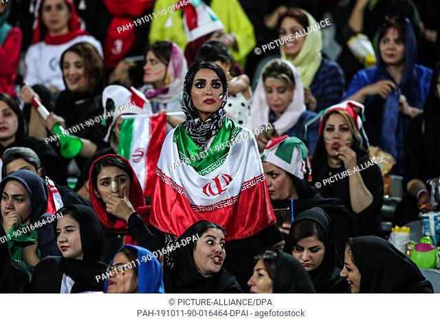10 October 2019, Iran, Tehran: Iranian women attend the FIFA soccer World Cup qualification match between Iran and Cambodia at the Azadi Stadium
