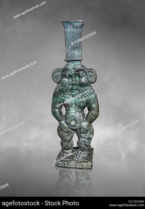 Ancient Egyptian bronze statue of Bes, Old Kingdom, Egyptian Museum, Turin. Grey background