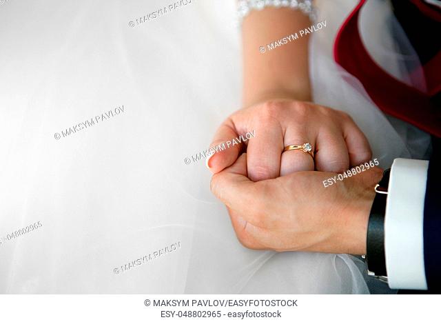 wedding theme, holding hands newlyweds. Close up
