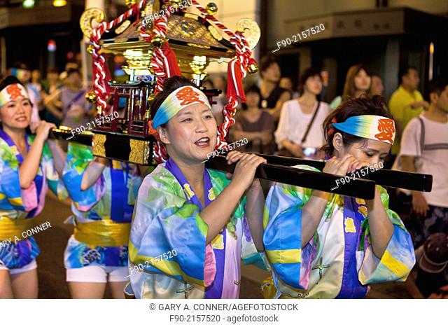 Women carry mikoshi (portable shrine) at Awa Odori Festival in Kagurazaka, Tokyo, Japan
