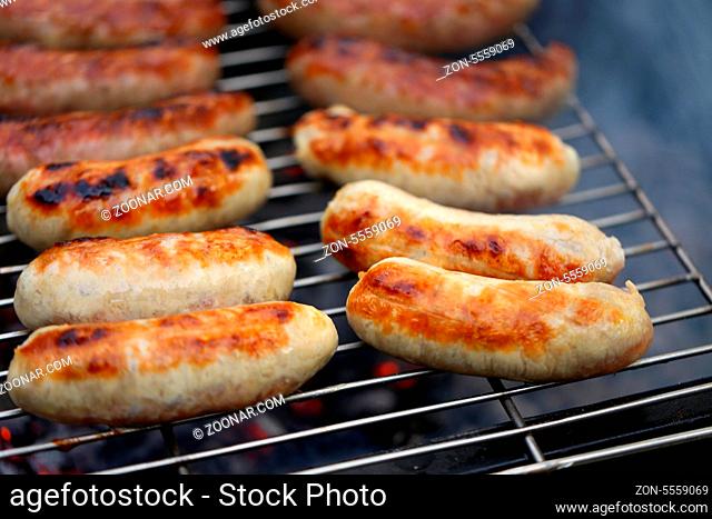 Nicely grilled sausages on a whole background