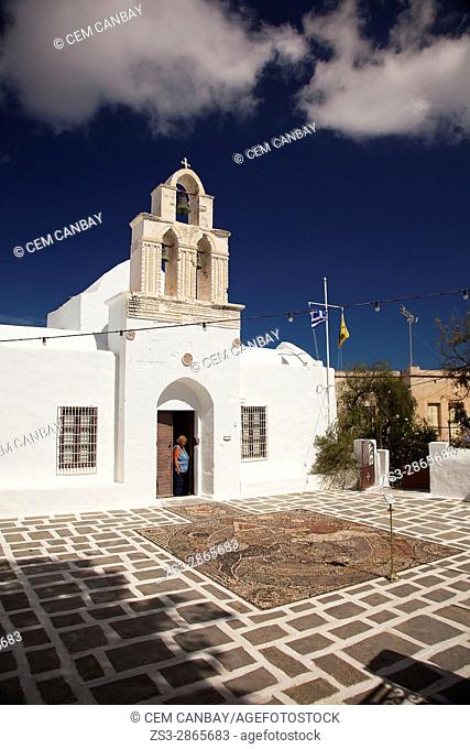 Woman at the door of the Church Of The Holy Trinity- today the Ecclesiastical Museum of Milos, Adamas, Milos, Cyclades Islands, Greek Islands, Greece, Europe