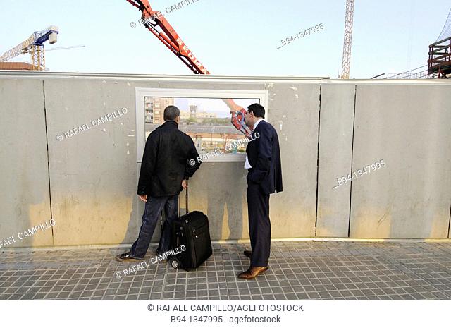 Men looking at construction site, Plaça de les Glories, Barcelona, Catalonia, Spain