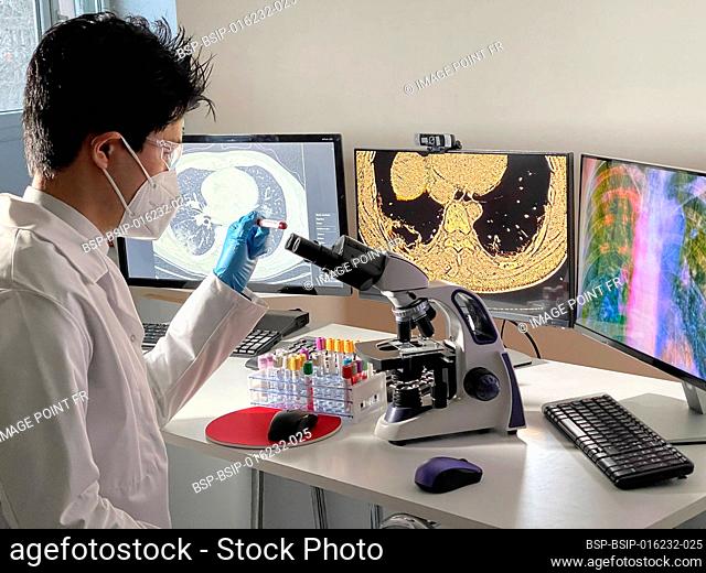 Laboratory technician doing research with images of the coronavirus on a computer