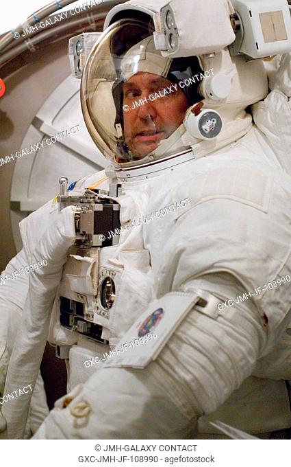 Astronaut Michael J. Foreman, STS-123 mission specialist, participates in an Extravehicular Mobility Unit (EMU) spacesuit fit check in the Space Station Airlock...