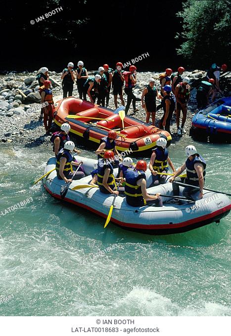 White-water rafting on River Dranse. Inflatable dinghies. People in safety gear/ helmets and life jackets