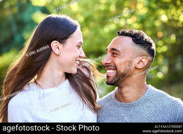 Smiling young couple looking at each other