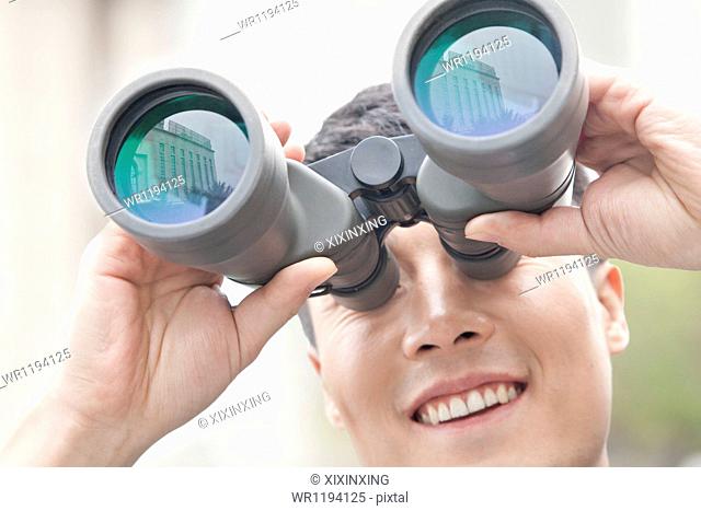 Close Up of Businessman Using Binoculars, Reflection