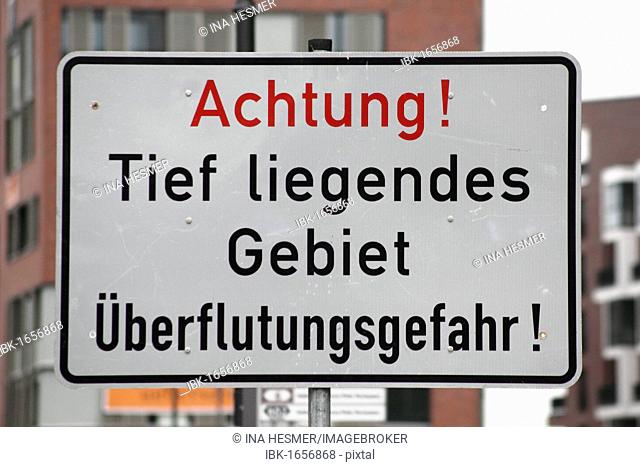 Warning sign Achtung! Tief liegendes Gebiet, Ueberflutungsgefahr!, German for Caution! Low-lying area, danger of flooding!, harbour