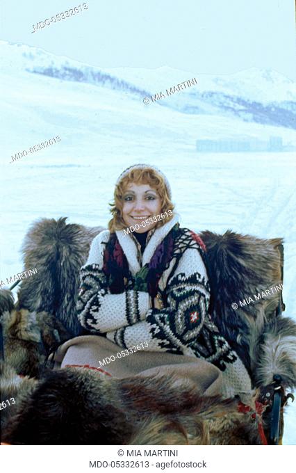 The singer Mia Martini (Domenica Rita Adriana Bertè) on a horse-drawn sleigh. Livigno, Italy. 1973