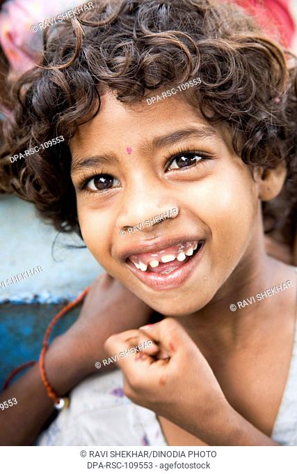 South Asian Indian Girl from Bheel tribe smiling , Bheel basti Village , Delwara , Udaipur , Rajasthan , India
