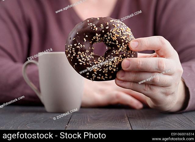 man eating a chocolate donut