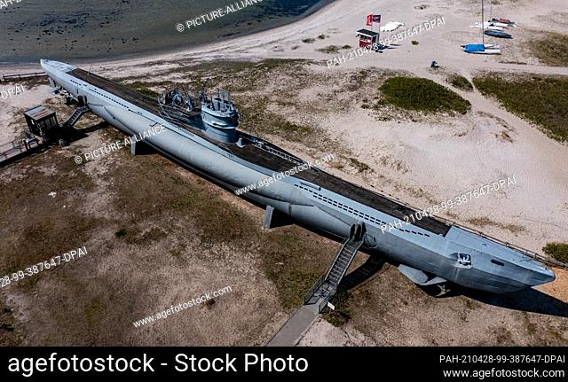 dpatop - 28 April 2021, Schleswig-Holstein, Laboe: Like a beached whale, the museum submarine U995 lies in the sun on the beach of Laboe (aerial view with a...