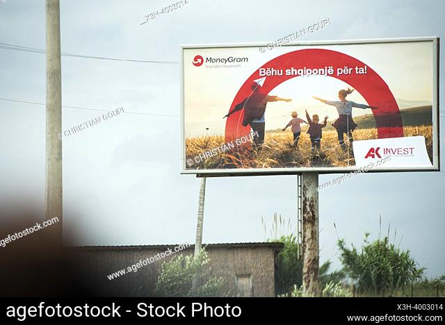 Billboard seen from inside a vehicle on the highway approaching Tirana, Albania, Southeastern Europe