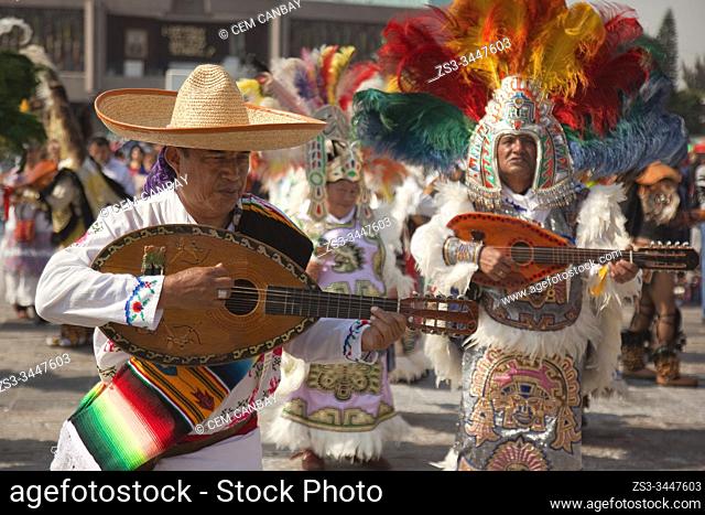 Indigenous dancers in traditional costumes perform at the pilgrimage to Our Lady of Guadalupe Basilica during the Virgen de Guadalupe Festival in Mexico City