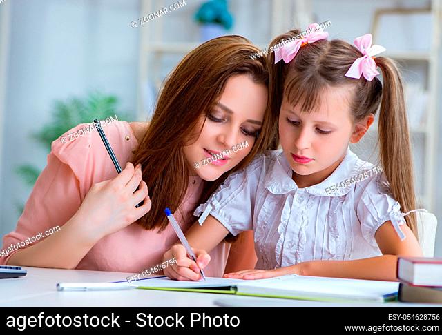 The mother helping her daughter to do homework