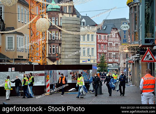 01 December 2020, Rhineland-Palatinate, Trier: Police, fire brigade and rescue teams are on duty near the pedestrian zone where a car has hit several people and