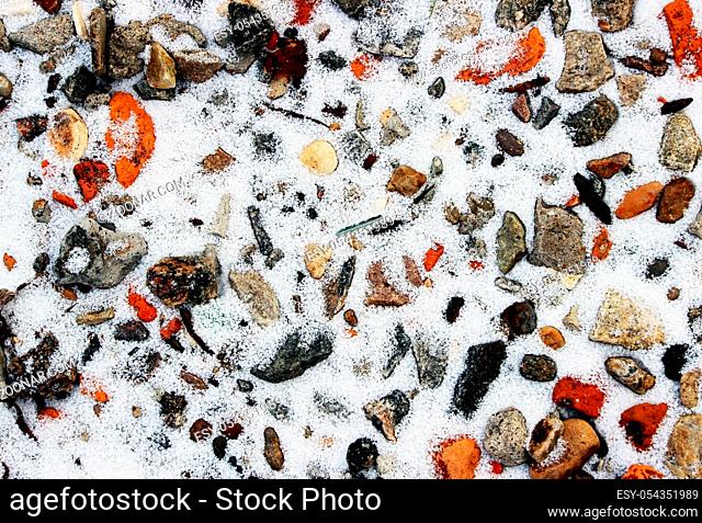 closeup texture of a stony coast of river in winter