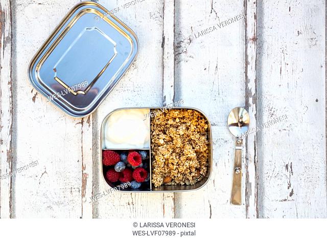 Box with granola, greek yogurt, blueberries and raspberries