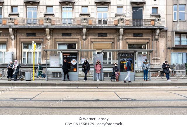 Ghent, Flanders, Belgium. People of mixed race waiting for the tramway at the public transportation platform