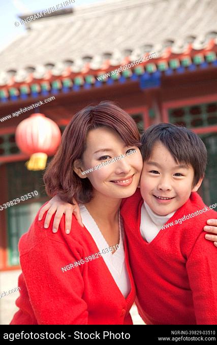 Portrait of mother and son outside traditional Chinese building