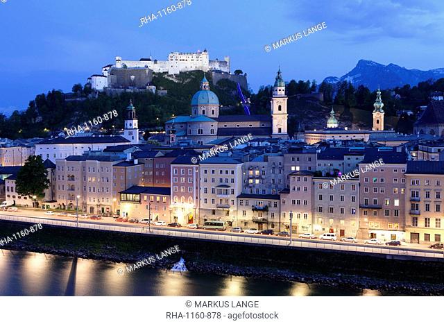 High angle view of the old town, UNESCO World Heritage Site, with Hohensalzburg Fortress, Dom Cathedral and Kappuzinerkirche Church at dusk, Salzburg