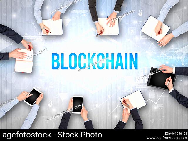 Group of Busy People Working in an Office with BLOCKCHAIN inscription, modern technology concept