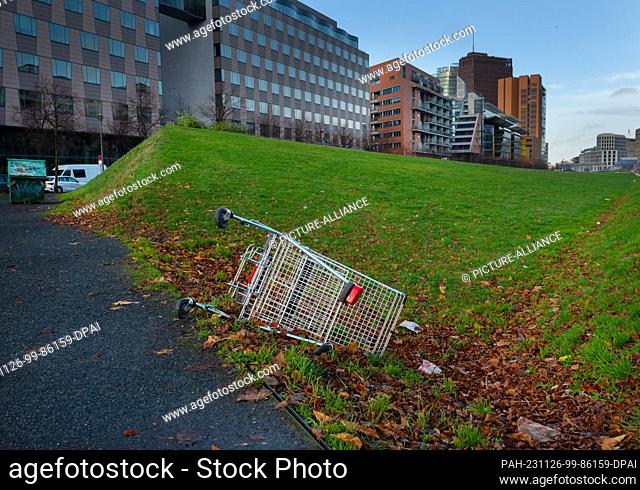 19 November 2023, Berlin: 19.11.2023, Berlin. A discarded shopping cart lies around 100 meters from Potsdamer Platz in Tilla-Durieux-Park