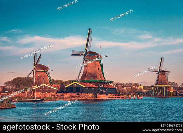 Windmills at famous tourist site Zaanse Schans in Holland in twilight after sunset. Zaandam, Netherlands