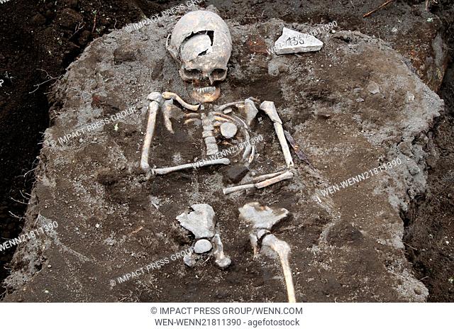 Archaelogists inspects a grave with a skeleton with an iron rod penetrated the heart body area, dated back in the Middle Ages in the ancient Thracian temple of...
