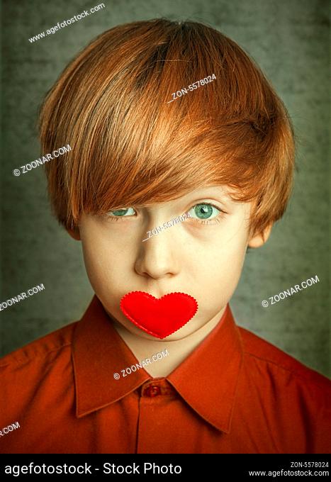Portrait of a boy with hearts on face
