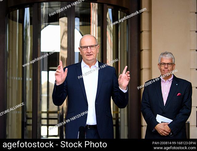 14 August 2020, Brandenburg, Potsdam: Dietmar Woidke (l, SPD), Minister President of Brandenburg, speaks at the beginning of his press tour in front of the...