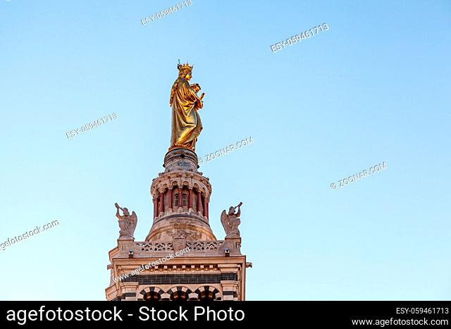 Golden Statue of the Madonna Holding the little Jesus on the top of Notre-Dame de la Garde in Marseilles, France
