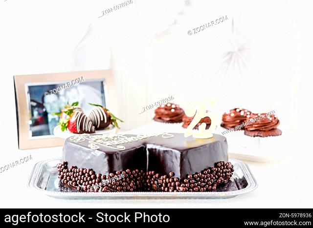 Celebrating wedding anniversary with heart shape chocolate cake