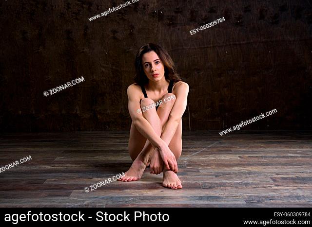 Abstract and stress emotional concept. depressed girl in lonely mood, theme of stressful. Sad woman sitting alone in empty room