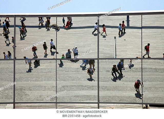 Passersby reflected in the facade of the Maremagnum leisure center, Port Vell, Barcelona, Catalonia, Spain, Europe, PublicGround