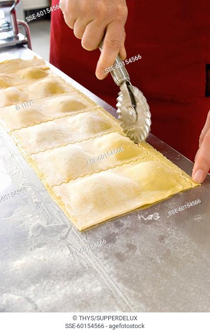 Cutting the raviolis with the pasta cutter