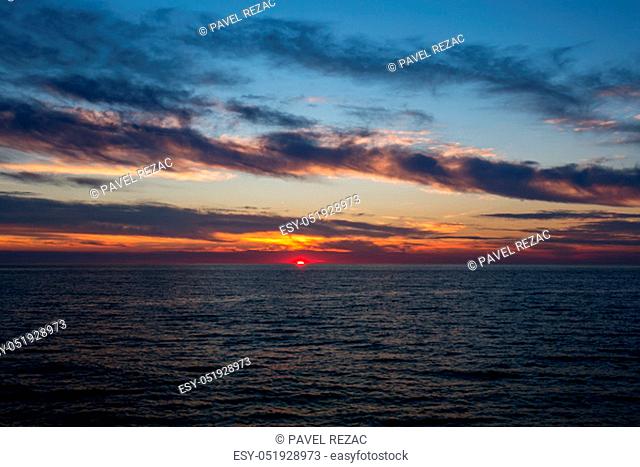 Beautiful sky with clouds at sunset over Adriatic sea near Peschici town on Gargano peninsula, Italy