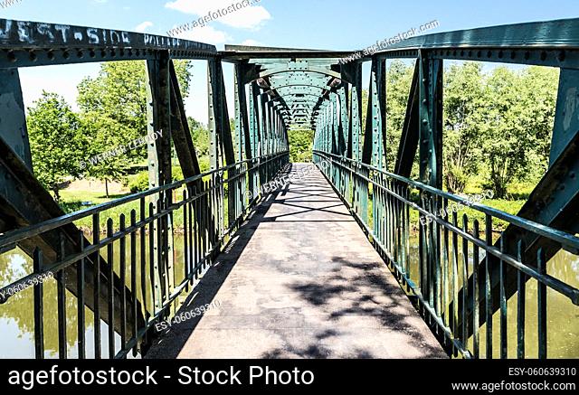 Pollare, Belgium - 05 16 2018: Metal pedestrian bridge over the River Dender