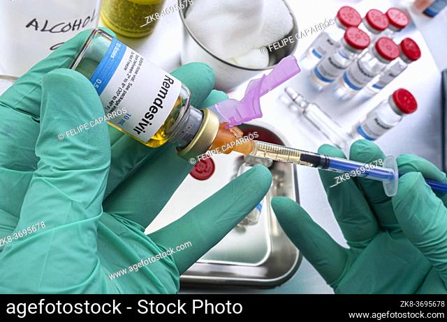 Nurse prepares medical syringe with remdesivir in a hospital, conceptual image